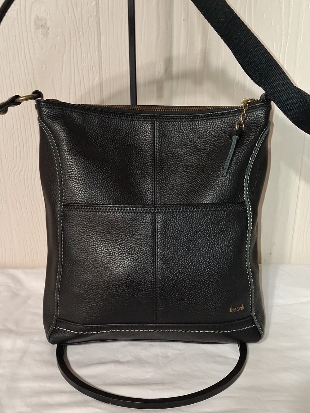 The Sak Taupe Fabric-Lined Black Pebbled Leather Crossbody with Brass Hardware
